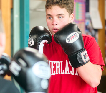 A student in boxing gloves during training