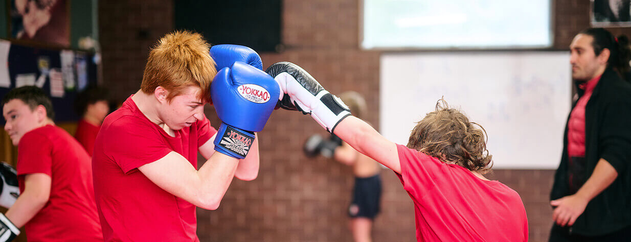 Students training with boxing gloves and pads