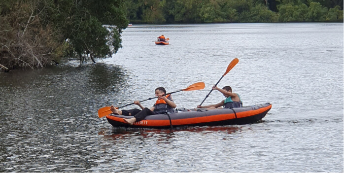 Students canoeing on a river at the Daylesford/Kimbolton Camp