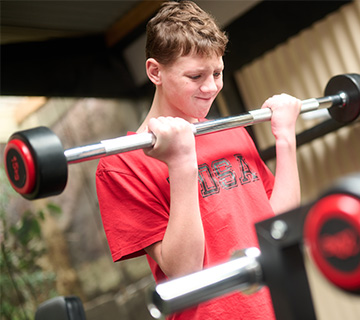 A student doing barbell curls